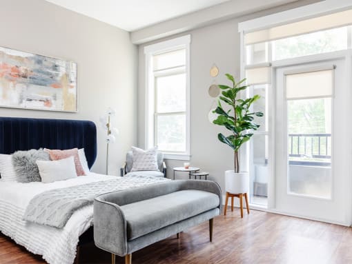 Bed with foot seating and plant at St. Marys Square Apartments, Raleigh, North Carolina