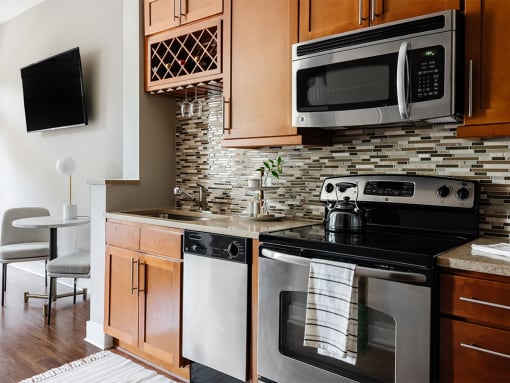 Kitchen with stainless steel appliances at St. Marys Square Apartments, Raleigh, NC