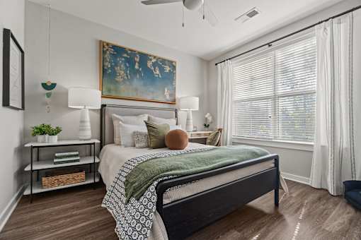 A bedroom with a large bed and a painting on the wall. at 1010 Dilworth Apartments, Charlotte 28204