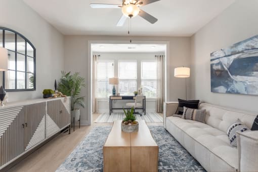 a living room with a white couch and a ceiling fan at Bristol at New Riverside, Bluffton South Carolina