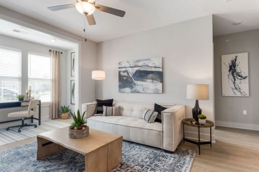 a living room with a couch and a ceiling fan at Bristol at New Riverside, Bluffton