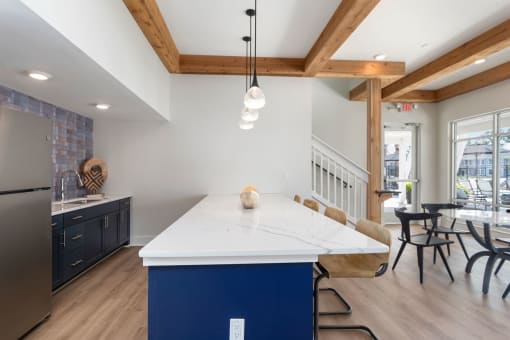 a kitchen with a large white counter top and a blue island at Bristol at New Riverside, South Carolina, 29910