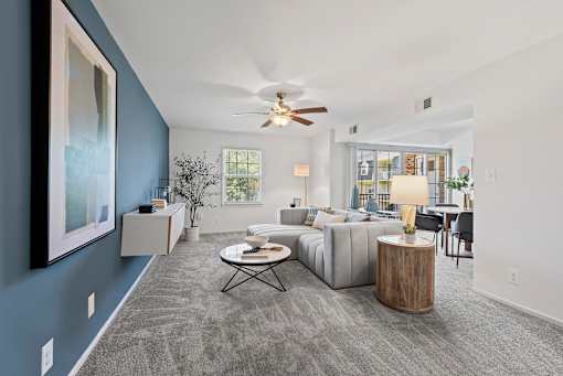a living room with a couch and a ceiling fan at Courthouse Square Apartments, Towson