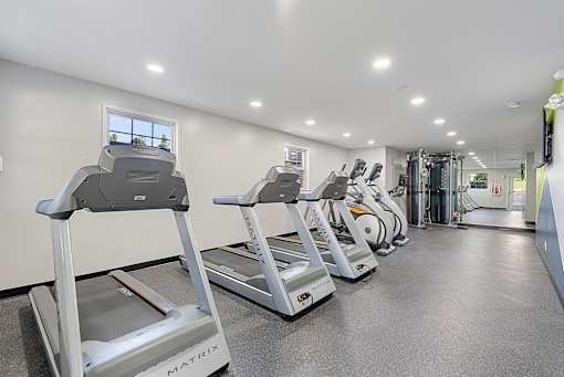a row of treadmills in a gym with cardio equipment at Courthouse Square Apartments, Towson