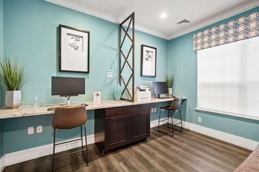 counter with computers and stools at The Grand Reserve at Tampa Palms Apartments, Tampa, FL, 33647