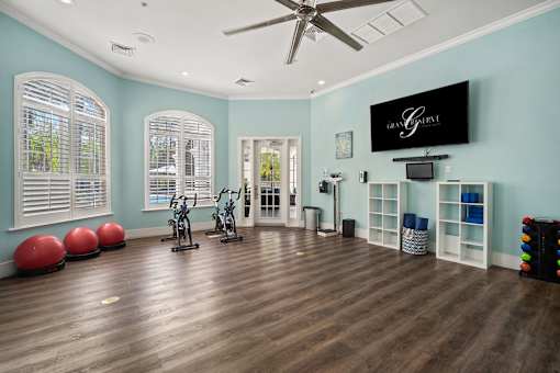 A room with a ceiling fan and exercise equipment at The Grand Reserve at Tampa Palms Apartments, Tampa, Florida