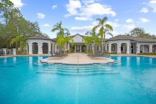 A large swimming pool in front of a house at The Grand Reserve at Tampa Palms Apartments, Florida, 33647