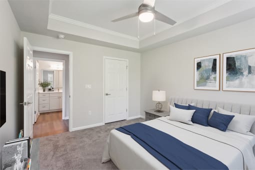 a bedroom with a large bed and a ceiling fan at The Bluestone Apartments, South Carolina