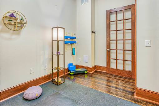 A room with a wooden floor and a wooden door at The Lofts at Reynolds Village Apartments, Asheville, NC