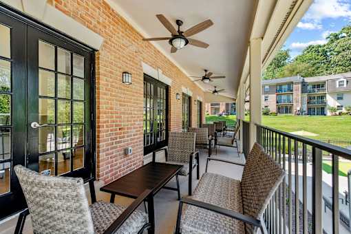 a patio with tables and chairs and a ceiling fan at Courthouse Square Apartments, Maryland, 21286