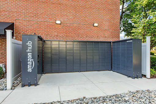 amazon hub package lockers in front of a brick building at Courthouse Square Apartments, Towson