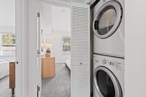 a small laundry room with a washing machine and a dryer at Courthouse Square Apartments, Maryland
