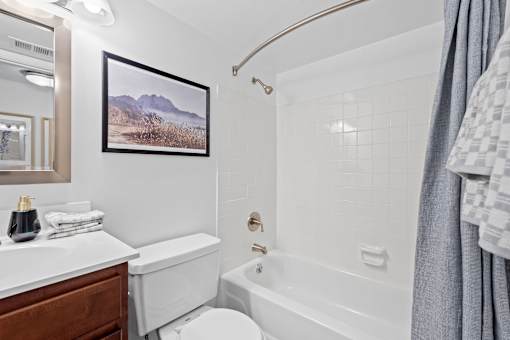 a white bathroom with a tub and a toilet and a sink at Courthouse Square Apartments, Towson, MD, 21286