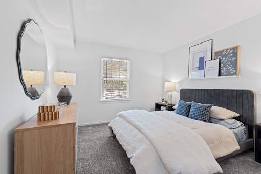 a bedroom with a bed and a mirror at Courthouse Square Apartments, Towson, MD, 21286