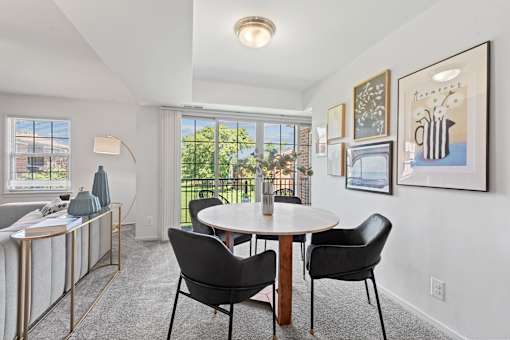 a dining room with a table and chairs and a window at Courthouse Square Apartments, Towson, 21286