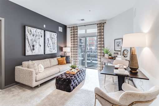 living room with blue walls and a couch and a table  at Dartmoor Place at Oxford Square Apartments, Maryland, 21076