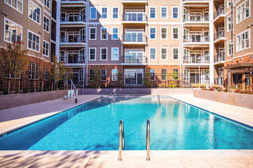 empty pool in front of an apartment building at Dartmoor Place at Oxford Square Apartments, Hanover, MD 21076