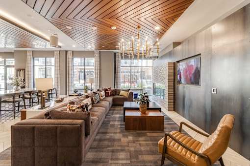 community room with couches and various seating at Dartmoor Place at Oxford Square Apartments, Hanover, MD 21076