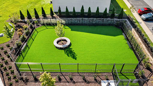 an aerial view of a dog park with green grass and a fountain at Courthouse Square Apartments, Towson, 21286