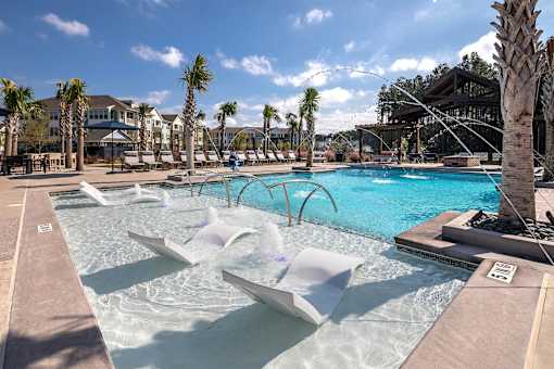 Pool side area with chairs at Elevate at Brighton Park, Summerville, SC
