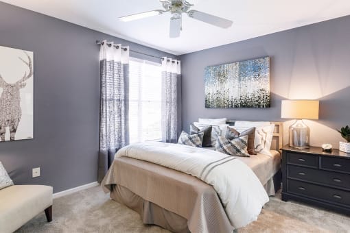 a bedroom with gray walls and a ceiling fan at Fortress Grove, Murfreesboro