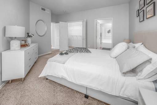 a white bedroom with a white bed and a white dresser at Henley Tampa Palms Apartments, Florida, 33647