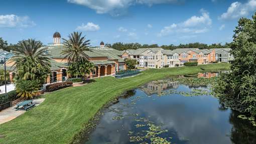 a building with a pond in front of it at Henley Tampa Palms Apartments, Tampa, FL, 33647