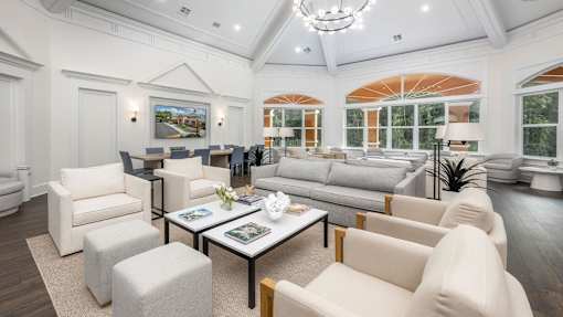 a white living room with couches and chairs at Henley Tampa Palms Apartments, Tampa, Florida