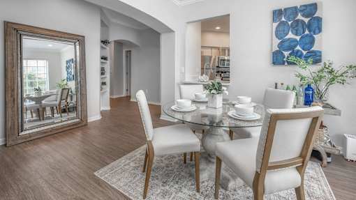 a dining room with a table and chairs at Henley Tampa Palms Apartments, Tampa, FL