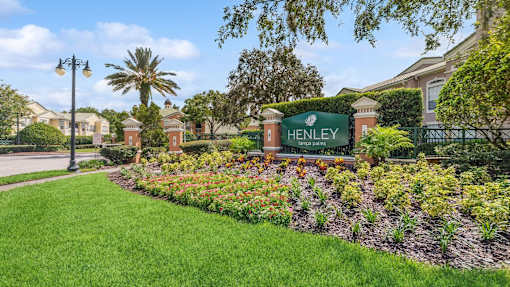 the sign is in front of a garden at Henley Tampa Palms Apartments, Tampa, Florida