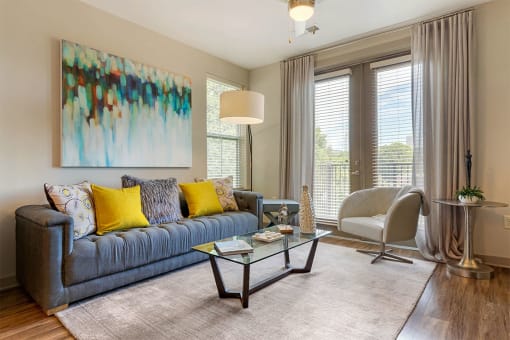 Sofa and chair with painting and sliding doors at 1010 Dilworth Apartments, Charlotte, NC