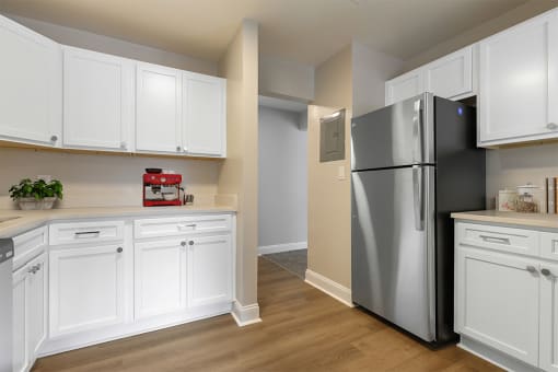 a kitchen with white cabinets and a stainless steel refrigerator at Padonia Village Apartments, Timonium MD