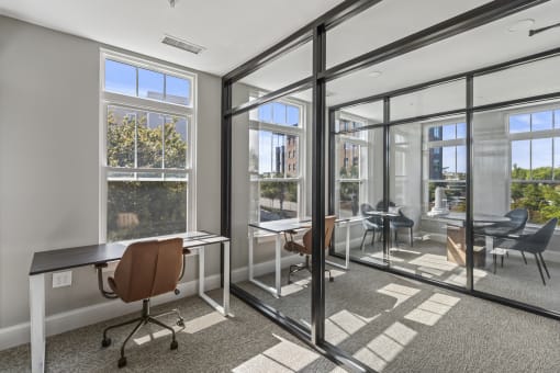 a conference room with glass doors and windows and desks at Central Island Square, Daniel Island, 29492