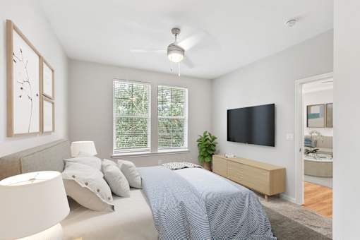 A bedroom with a bed, a television, and a window with blinds at Sweetgrass Landing, Mount Pleasant, SC