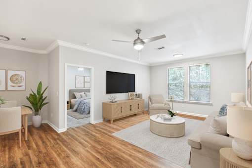 A living room with a television, a couch, a chair, and a potted plant at Sweetgrass Landing, Mount Pleasant, SC