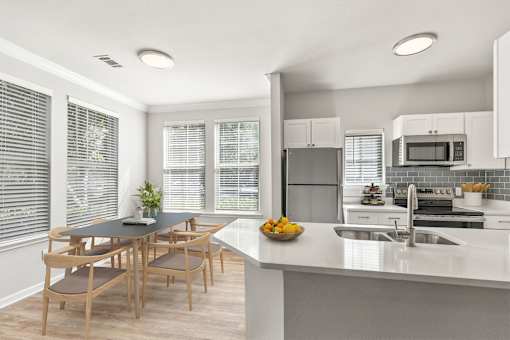 A modern kitchen with a dining table and chairs at Sweetgrass Landing, South Carolina, 29466