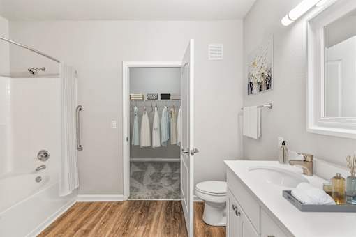 A bathroom with a white sink, toilet, and a shower with a white curtain at Sweetgrass Landing, Mount Pleasant, 29466