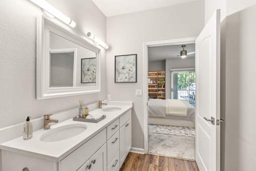 A white bathroom with a vanity and a mirror at Sweetgrass Landing, Mount Pleasant, SC