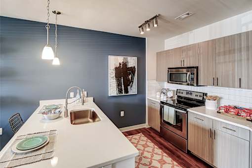 A kitchen with a white counter top and a sink at The Linden Apartments, Davidson, NC, 28036