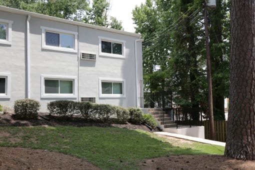 a white building with a tree in front of it