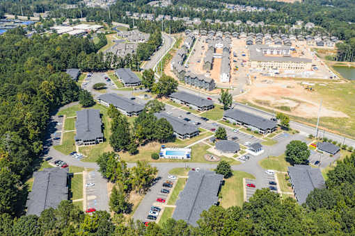 A bird's eye view of a residential area with houses and cars.