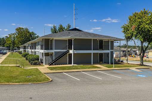 A building with a parking lot in front of it.
