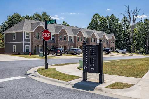 A stop sign is in front of a brick building.
