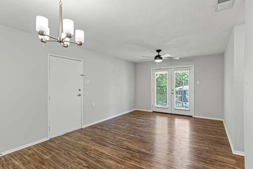 A room with a wooden floor and a ceiling fan.