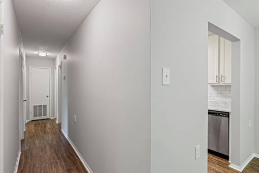 A long hallway with a door at the end.