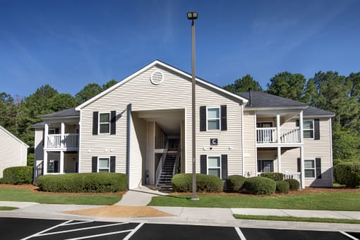an apartment building with a porch and a street light