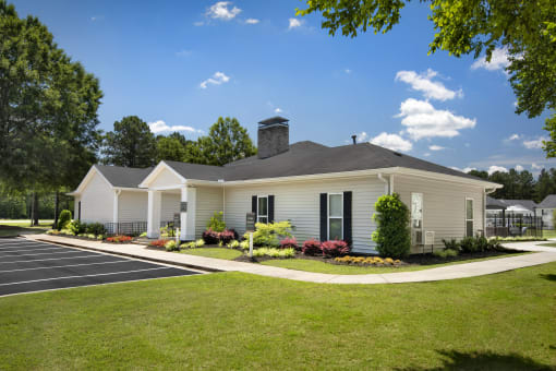 a white house with black shutters and a lawn and a driveway