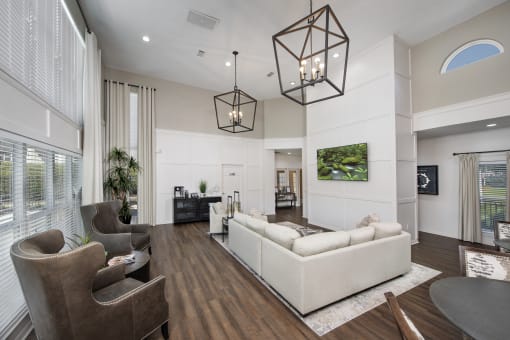 a living room with couches and chairs
