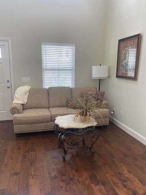 A living room with a couch and a table.