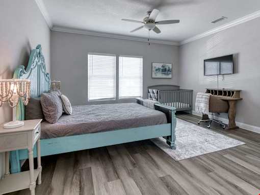 A baby's room with a crib and a bed.